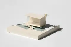 Maquete branca de uma casa sobre um livro